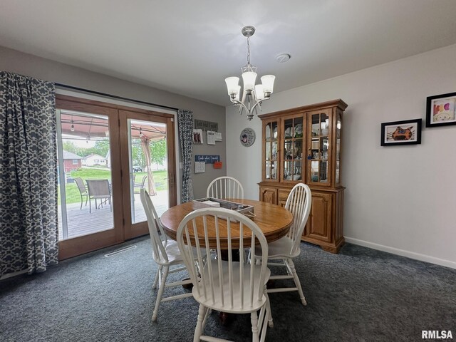 dining space featuring a chandelier, baseboards, and dark carpet