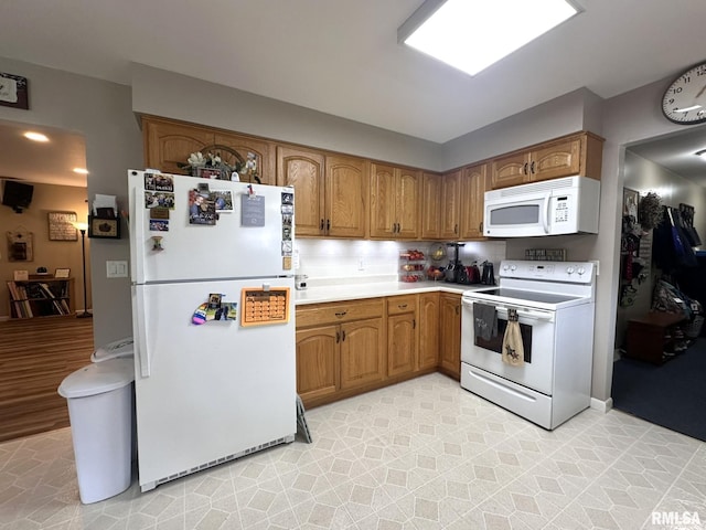kitchen featuring brown cabinetry, white appliances, light countertops, and tasteful backsplash
