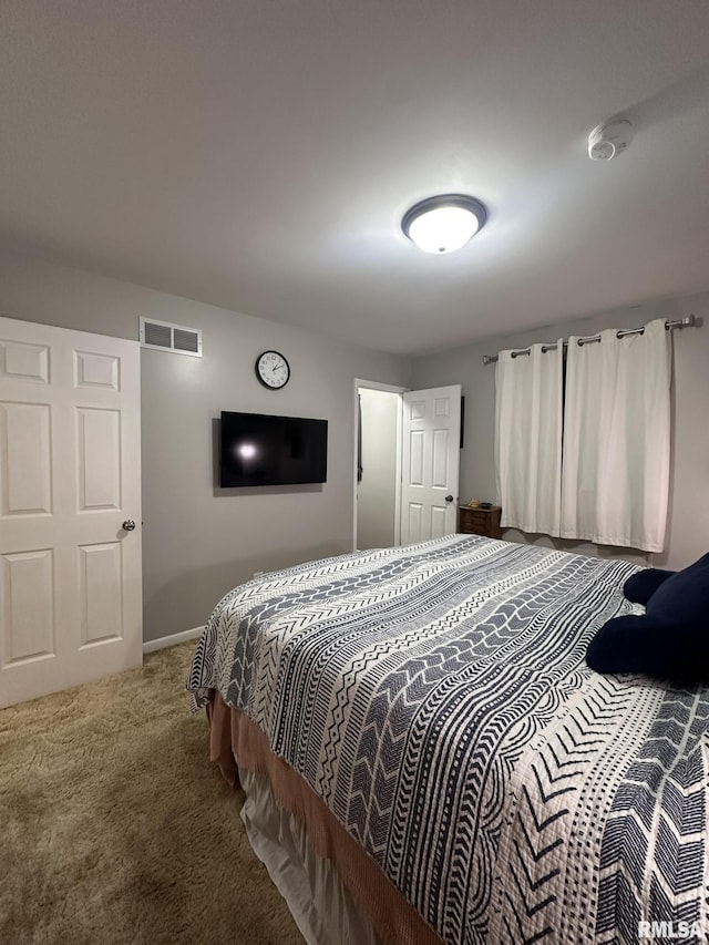 carpeted bedroom with baseboards and visible vents