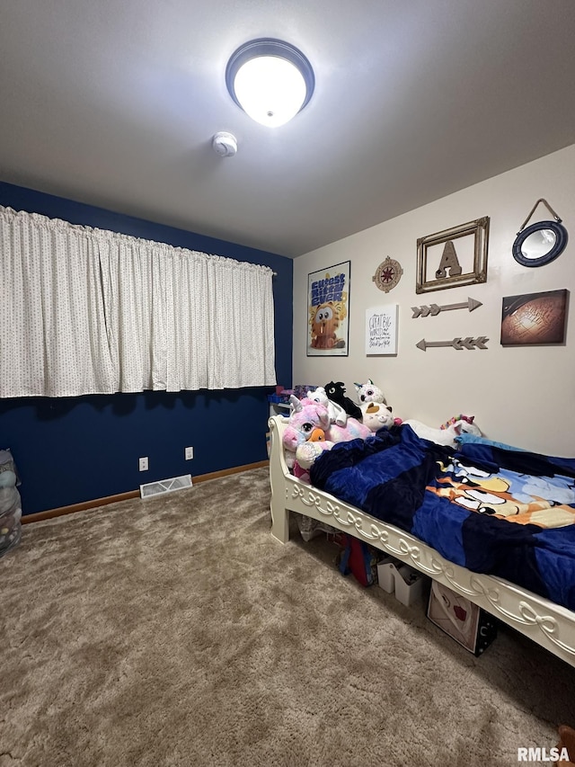 carpeted bedroom featuring visible vents