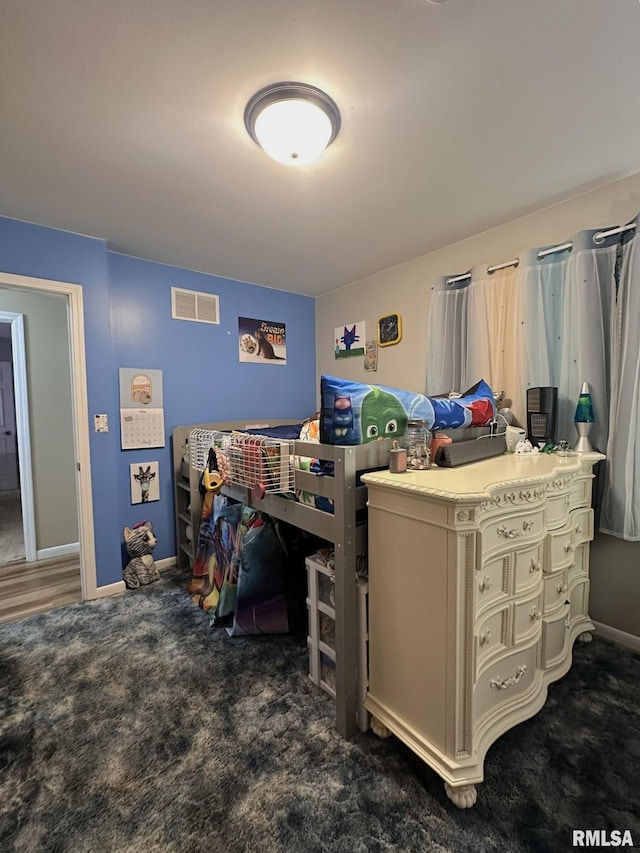 carpeted bedroom with visible vents and baseboards