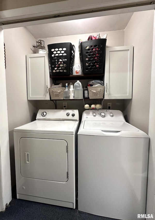 washroom featuring washer and dryer and cabinet space