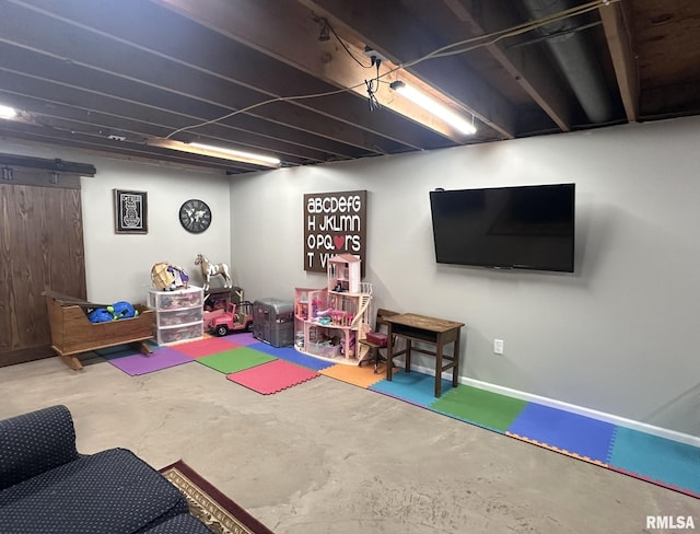 game room with concrete flooring