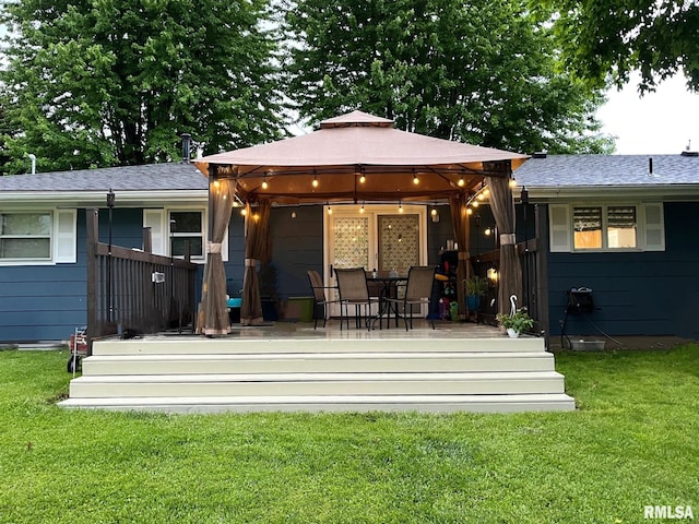 back of house featuring a lawn, a gazebo, and a deck