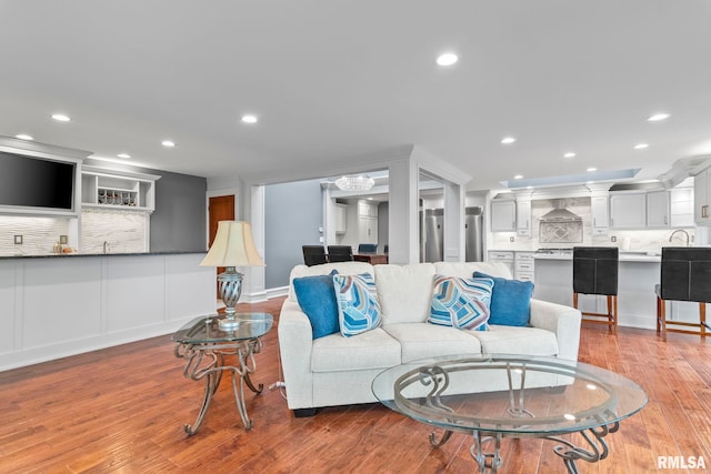 living area with light wood-style flooring and recessed lighting