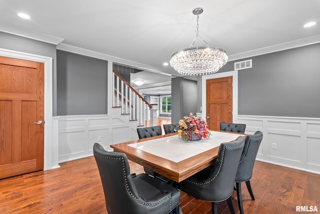 dining room with ornamental molding, a notable chandelier, stairway, and visible vents