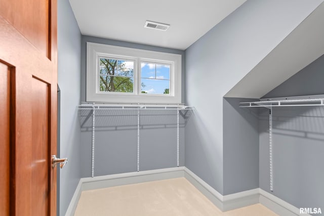 spacious closet featuring visible vents