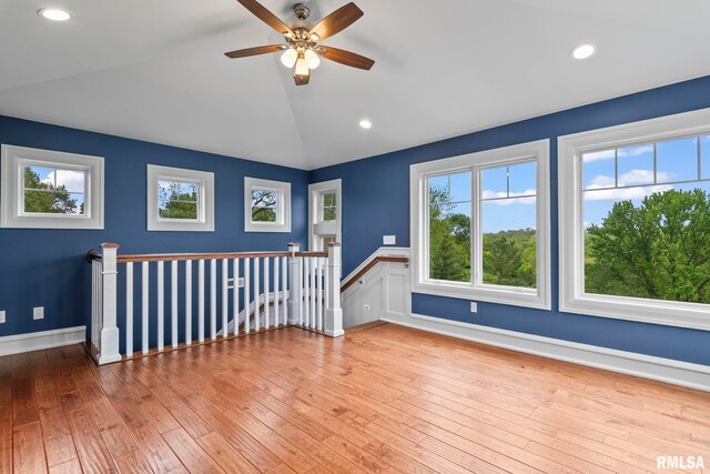 additional living space with light wood-style floors, vaulted ceiling, ceiling fan, and recessed lighting