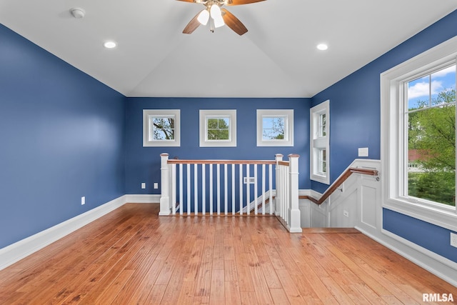 additional living space with a ceiling fan, lofted ceiling, wood-type flooring, and baseboards
