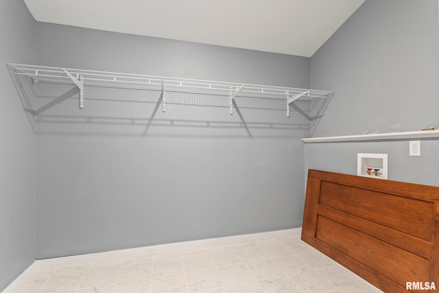 spacious closet with marble finish floor