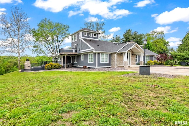 view of front facade with stone siding and a front yard