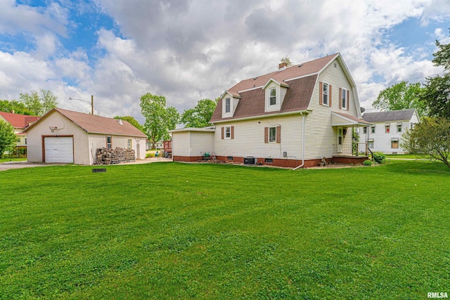 rear view of house featuring an outdoor structure, a gambrel roof, a garage, a chimney, and a lawn