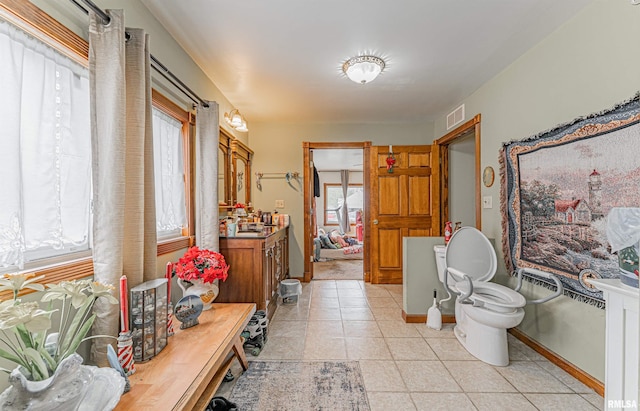 bathroom with tile patterned flooring, baseboards, visible vents, and vanity