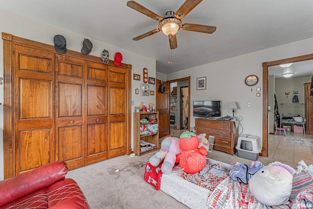 living area with a ceiling fan and carpet floors