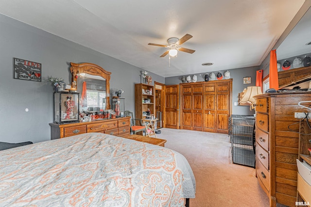bedroom with light carpet and a ceiling fan