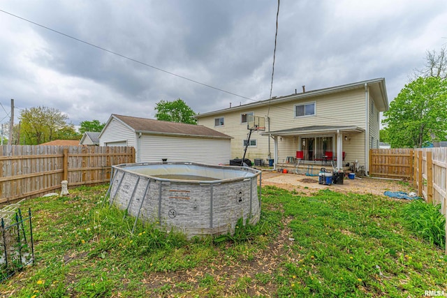 rear view of house with a fenced backyard and a fenced in pool
