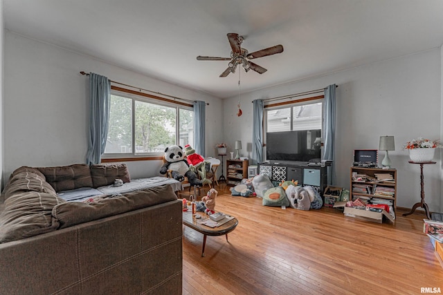 living room featuring wood-type flooring and ceiling fan