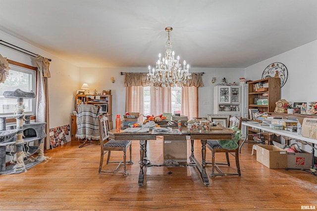 dining room with a notable chandelier and wood finished floors