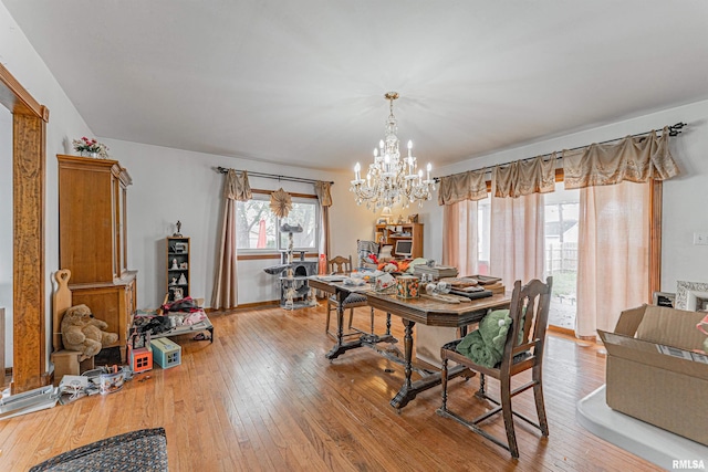 dining room featuring an inviting chandelier and light wood-style flooring