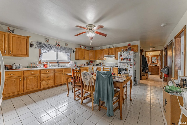 dining space featuring light tile patterned floors and ceiling fan