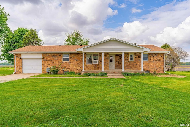 ranch-style home featuring a porch, a garage, brick siding, and a front yard