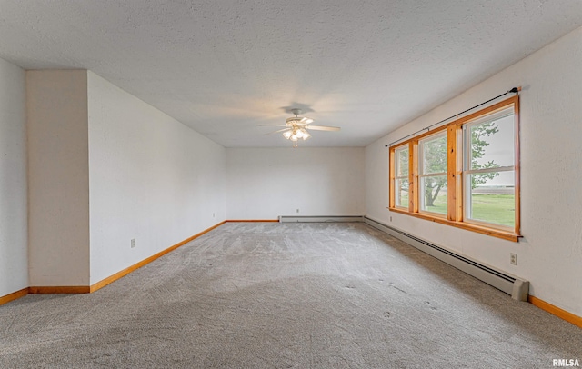 carpeted spare room with a ceiling fan, baseboards, a baseboard radiator, and a textured ceiling