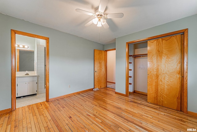 unfurnished bedroom featuring a ceiling fan, a closet, baseboards, connected bathroom, and hardwood / wood-style flooring