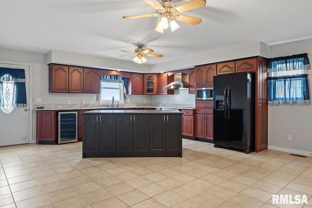 kitchen with beverage cooler, black fridge, wall chimney exhaust hood, visible vents, and stainless steel microwave