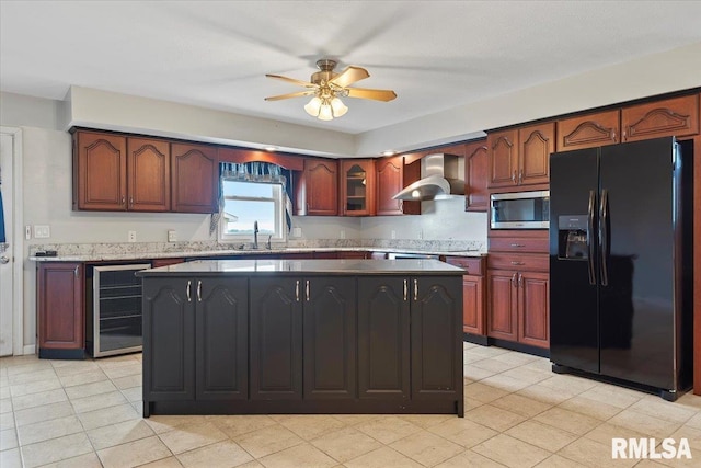 kitchen with beverage cooler, a ceiling fan, black fridge, wall chimney exhaust hood, and stainless steel microwave