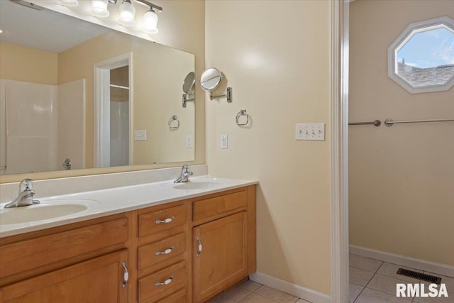 full bath with a sink, tile patterned flooring, and visible vents