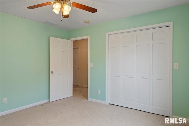 unfurnished bedroom with ceiling fan, carpet flooring, a closet, and baseboards