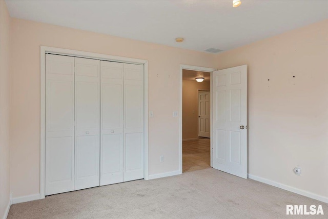 unfurnished bedroom featuring carpet flooring, a closet, visible vents, and baseboards