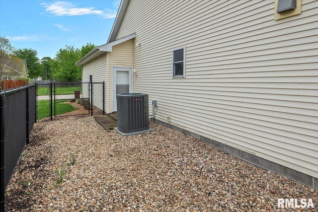 view of side of property featuring cooling unit, a gate, and fence