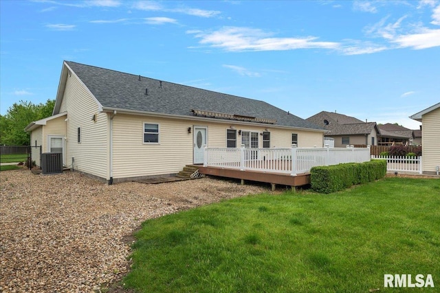 rear view of property with a yard, cooling unit, a wooden deck, and fence