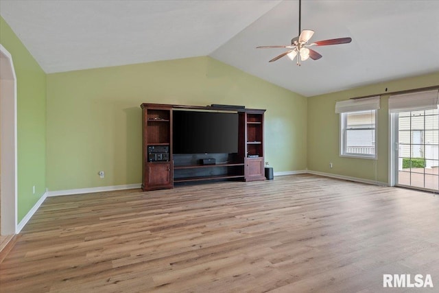 unfurnished living room featuring baseboards, ceiling fan, light wood-type flooring, and vaulted ceiling