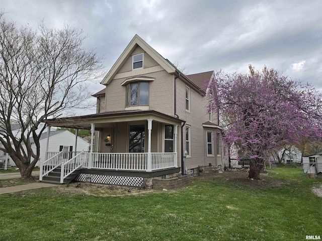 victorian house with a front yard and a porch