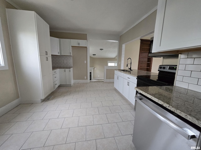 kitchen with a sink, baseboards, backsplash, dishwasher, and light stone counters