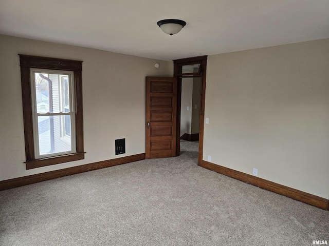 carpeted spare room with baseboards
