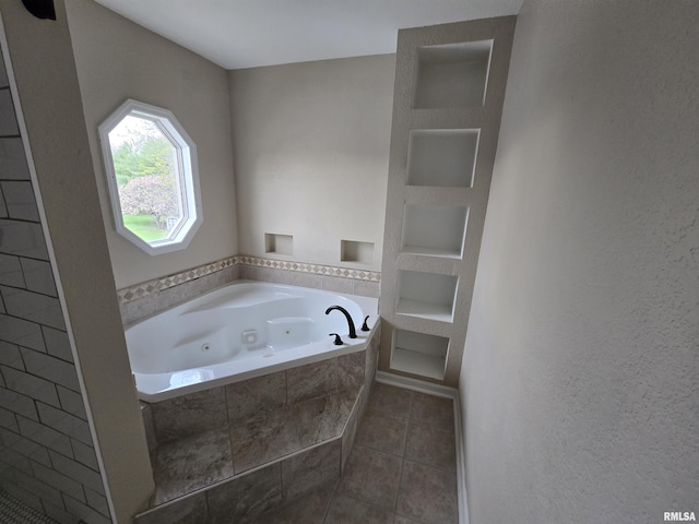 bathroom featuring a tub with jets and tile patterned flooring