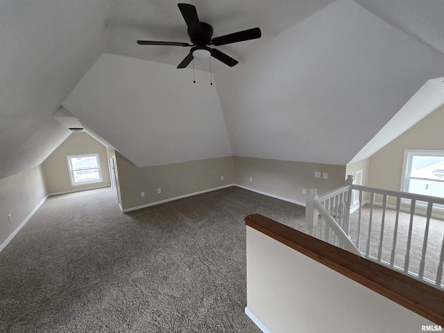 bonus room with lofted ceiling, baseboards, and carpet floors