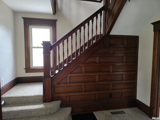 staircase with carpet, visible vents, and baseboards