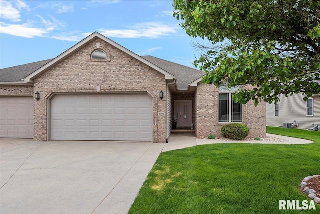 single story home featuring concrete driveway, a front lawn, brick siding, and a garage
