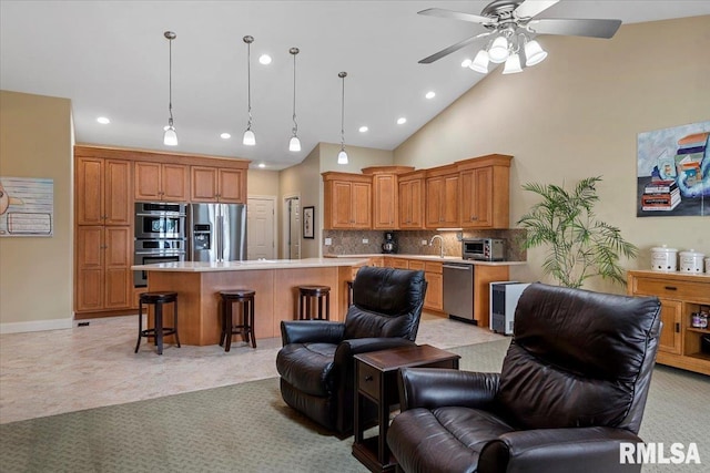 living area with lofted ceiling, ceiling fan, a toaster, and recessed lighting