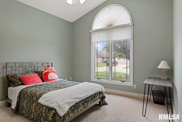 bedroom with baseboards, carpet, and vaulted ceiling