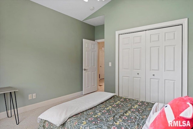 carpeted bedroom with a closet, vaulted ceiling, and baseboards