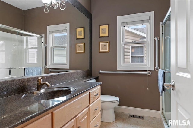 bathroom featuring toilet, visible vents, baseboards, a shower stall, and vanity