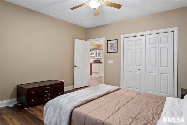bedroom featuring baseboards, a closet, a ceiling fan, and wood finished floors