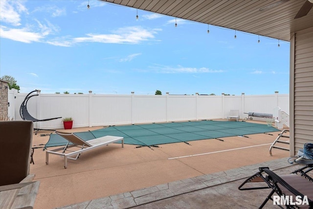 view of pool with a patio area, a fenced in pool, and fence