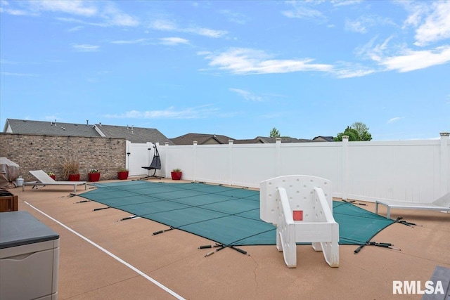 view of swimming pool featuring fence, a fenced in pool, and a patio area