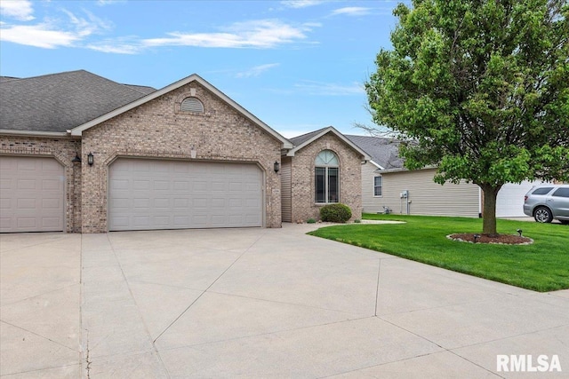 ranch-style house with an attached garage, concrete driveway, a shingled roof, a front lawn, and brick siding